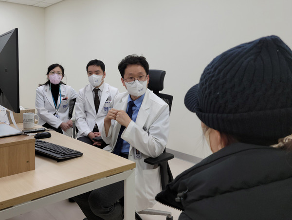 Doctors at the Department of Genomic Medicine at Seoul National University HJospital conduct multidisciplinary treatment for a patient visiting their clinic.