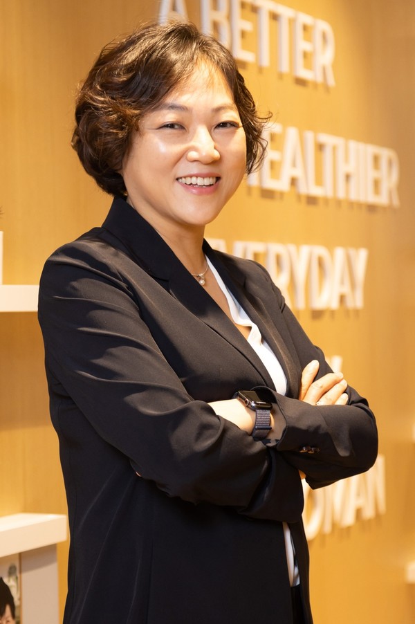 Organon Korea CEO Kim So-eun stands in front of her company's mission statement.