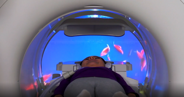 A patient is seen looking at the MR Theater while taking an MRI. (Source: Canon Medical Systems)