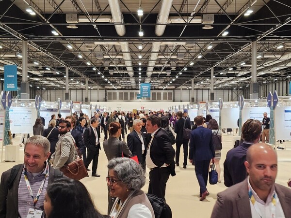 Participants and visitors look around the booths at the European Society for Medical Oncology Annual Meeting (ESMO 2023) at the Ipema Convention Center in Madrid on Sunday (local time).