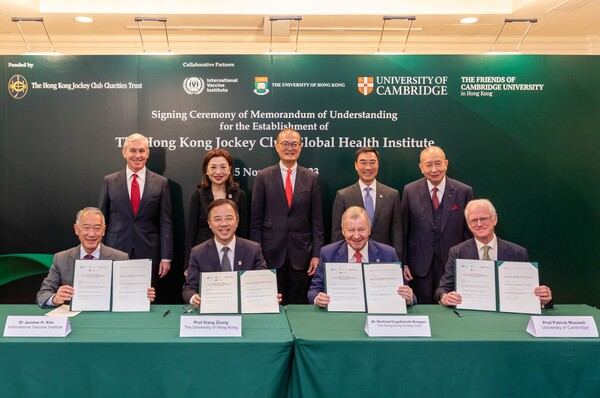 Officials from IVI, UCAM, HKU, and HKJCCT hold up the agreement after signing the MOU to establish a Hong Kong Jockey Club Global Health Institute in Hong Kong. From left are IVI Director General Jerome Kim, HKU President and Vice-Chancellor Professor Xiang Zhang, Hong Kong Jockey Club CEO Winfried Engelbrecht-Bresges, and University of Cambridge Professor of Physics and Head of the School of Clinical Medicine.