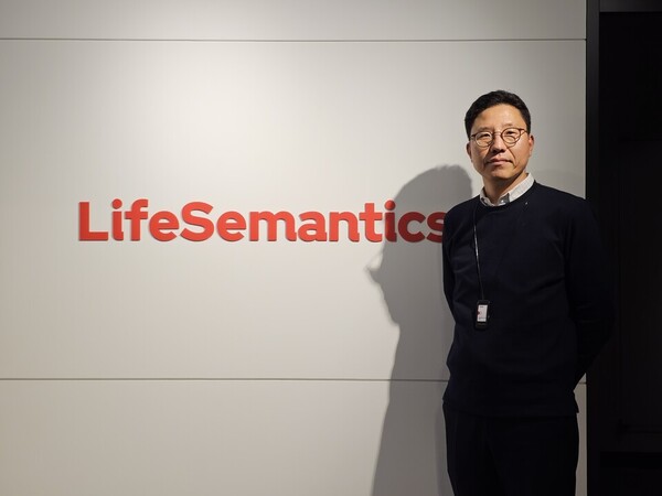 Hong Seung-yong Hong, head of the MD Business Division at LifeSemantics, poses beside the company’s corporate identity in its headquarters office in Gangman-gu, Seoul, in December 2023. (KBR photo)